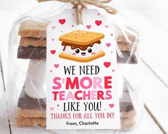 May include: A white gift tag with pink hearts and a cartoon s'more. The text on the tag reads "We need s'more teachers like you! Thanks for all you do! From, Charlotte".