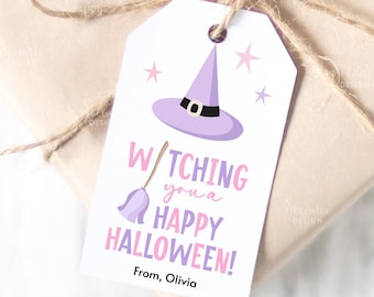 May include: A white gift tag with a purple witch hat, broom, and stars. The text reads "Witching you a Happy Halloween!" in pink and purple. The tag is tied to a wrapped gift with twine.