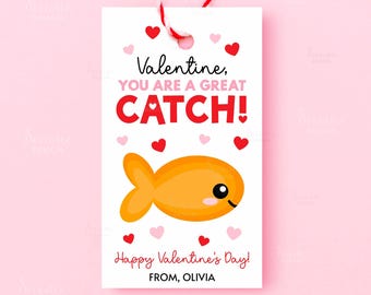 May include: A Valentine's Day gift tag with a cartoon goldfish illustration. The tag reads "Valentine, YOU ARE A GREAT CATCH!" in red and black text, with pink and red hearts. The tag is tied with red and white twine.