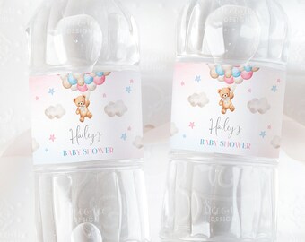 May include: Two clear plastic water bottles with pink and blue labels. The labels feature a teddy bear holding balloons and the text "Hailey's Baby Shower".