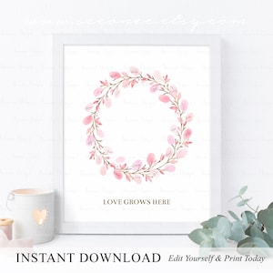 May include: A printable pink floral wreath with the text "LOVE GROWS HERE" in gold lettering. This digital download is perfect for a baby shower or other special event.