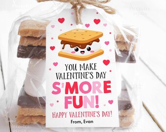 May include: A clear cellophane bag tied with twine, containing s'mores ingredients and a Valentine's Day tag. The tag features a cartoon s'more with hearts and the text "You Make Valentine's Day S'more Fun! Happy Valentine's Day!"