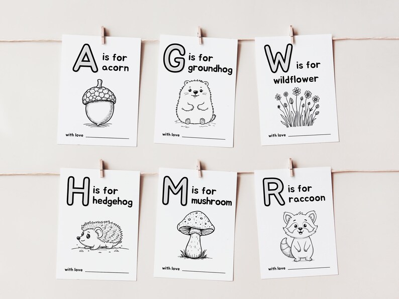 May include: Black and white printable alphabet flashcards with illustrations of an acorn, groundhog, wildflower, hedgehog, mushroom, and raccoon. Each card features a letter, the word "is for", and the name of the animal or plant.