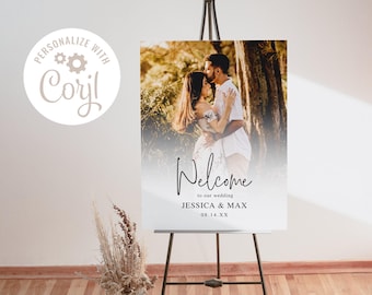 May include: A wedding welcome sign with a photo of a couple in a forest setting. The sign says "Welcome to our wedding Jessica & Max 08.14.XX"