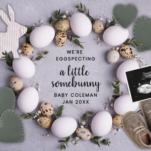 May include: A baby announcement card with a white bunny rabbit, white eggs, and a baby ultrasound image. The text reads "We're eggspecting a little somebunny, Baby Coleman, Jan 20XX".
