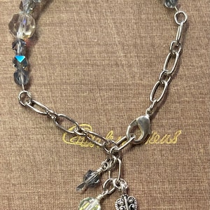 May include: A rustic wooden sign with the text "Welcome to our home" in white lettering. The sign features a distressed finish and a simple, inviting design, perfect for front door decor.