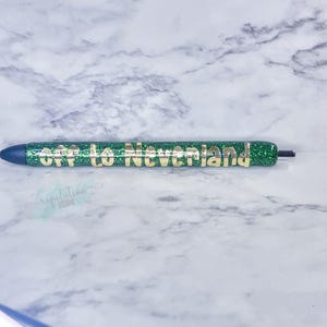 May include: A green glitter pen with gold lettering that reads "Off to Neverland".