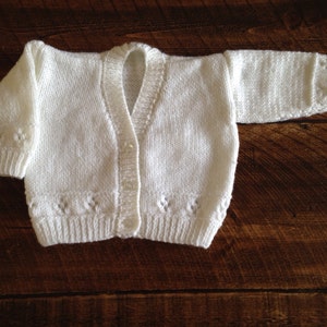 Adorable hand knitted baby cardigan available in a choice of colours and sizes.