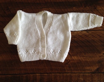 Adorable hand knitted baby cardigan available in a choice of colours and sizes.