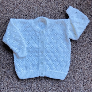 Pretty hand knitted baby cardigan available in choice of colours. Suitable for both boys and girls. image 1