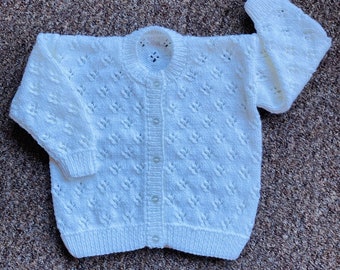Pretty hand knitted baby cardigan available in choice of colours. Suitable for both boys and girls.