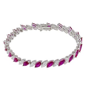 May include: A silver bracelet featuring alternating marquise-cut ruby and diamond gemstones. The bracelet has a secure clasp closure and is designed with a repeating pattern of red and white stones. The gemstones are set in a silver metal.