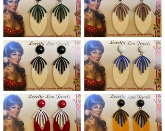 May include: Six pairs of vintage-inspired earrings with different colored tops and geometric designs. The earrings are on a white background with the text "Loretta Lou Jewels" and "vintage inspired & custom made jewelry".