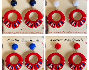 May include: Four pairs of red, white, and blue earrings with a circle design. The earrings are on a white background with the text "Loretta Lou Jewels" and "vintage inspired & custom made jewelry".