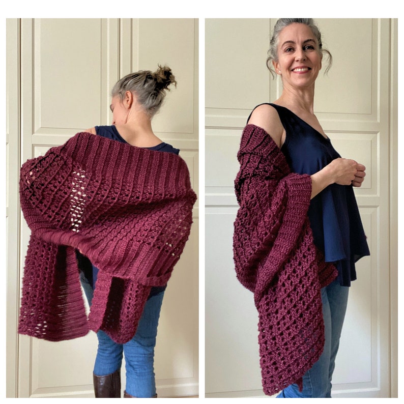 May include: A burgundy crochet shawl with a lacy pattern. The shawl is draped over the shoulders of a person wearing a blue tank top and jeans.