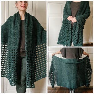 May include: A deep green crochet shawl with a lacy pattern. The shawl is draped over a person's shoulders and is worn with a brown sweater and green pants.