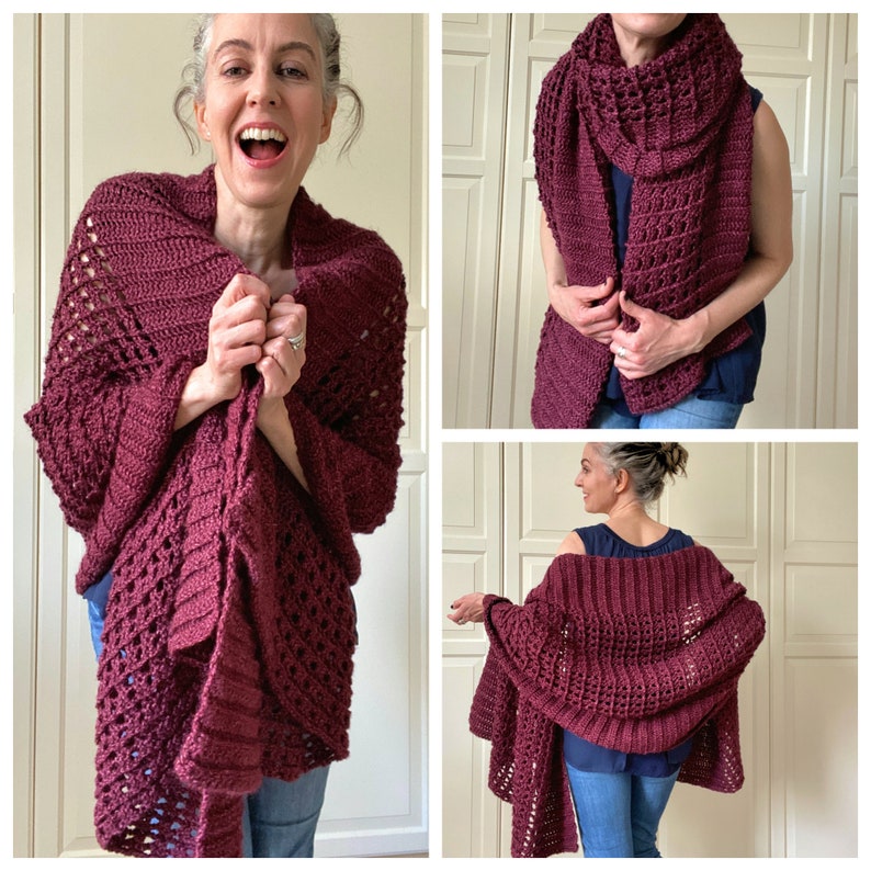 May include: A burgundy crochet shawl with a lacy pattern. The shawl is draped over a person's shoulders and is being held in their hands.