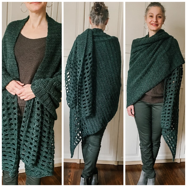 May include: A dark green crochet shawl with a lacy pattern. The shawl is draped over the shoulders of a person wearing black pants.