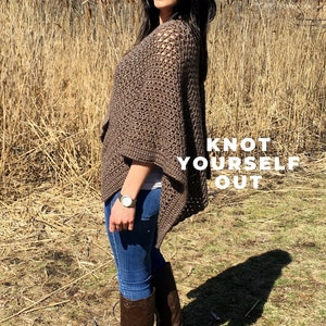 May include: A woman wearing a brown crochet poncho, blue jeans, brown boots, and sunglasses. The text "Knot Yourself Out" is superimposed on the image.