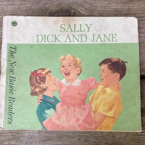 May include: A vintage children's book titled Sally, Dick and Jane from The New Basic Readers series. The cover features a green background with an illustration of three children laughing, including a girl in a pink dress and a boy in a yellow shirt.