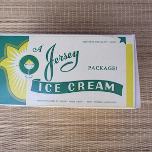 May include: A vintage ice cream package with the words "Jersey Ice Cream" in green script. The package has a yellow and green design with a sunburst graphic and the text "Contents One Quart Liquid".