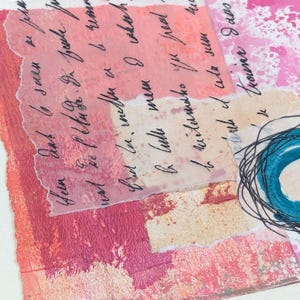 May include: Abstract mixed media artwork with layers of pink, peach, and white paper. Handwritten script is visible on translucent paper. A teal circle with black scribbled lines is in the lower right corner.