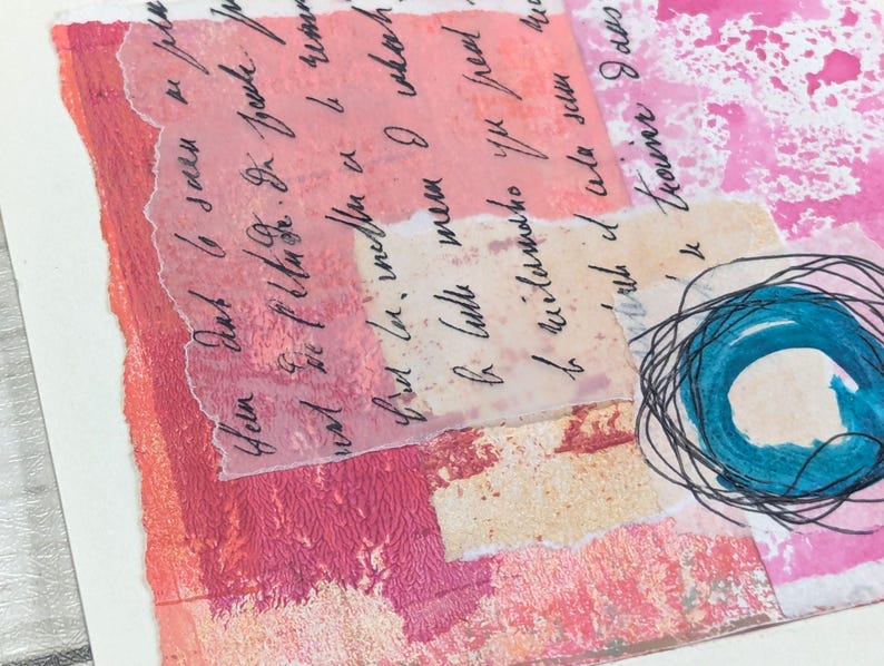 May include: Abstract mixed media artwork with layers of pink, peach, and white paper. Handwritten script is visible on translucent paper. A teal circle with black scribbled lines is in the lower right corner.