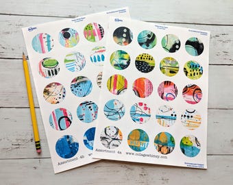 May include: Two sheets of Avery sticker paper with colorful, abstract circle designs. Each circle features a unique pattern with various colors and textures. A yellow pencil rests on the left side of the paper. The text "Assortment 4b" and "Assortment 4a" are visible.