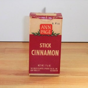 May include: Red and white box of Ann Page Stick Cinnamon, with the text "3 E 11" in the top right corner. The box reads "Net Wt. 1 1/2 oz." and "The Great Atlantic & Pacific Tea Co., Inc. Distributor".