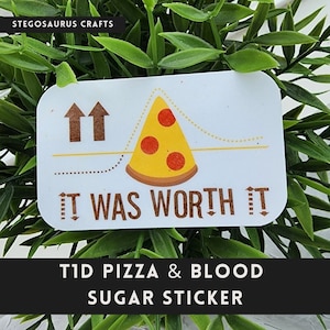 May include: A white sticker with a pizza slice graphic and the text "IT WAS WORTH IT". The sticker also includes the text "T1D PIZZA & BLOOD SUGAR STICKER" and the Stegosaurus Crafts logo.