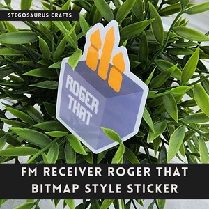 May include: A sticker with the text "ROGER THAT" on a blue and gray background, with an orange graphic. The sticker is surrounded by green leaves. The text "FM RECEIVER ROGER THAT BITMAP STYLE STICKER" is at the bottom.