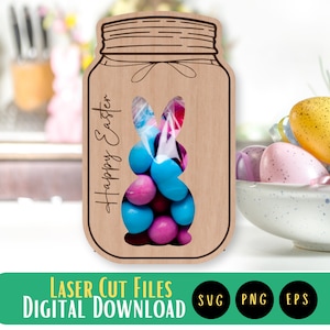 May include: A wooden cutout of a mason jar with a bunny rabbit shape cut out of the front. The jar has the text "Happy Easter" written on the side. The bunny rabbit shape is filled with blue and pink candy.