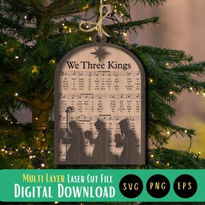 May include: A wooden Christmas ornament with a silhouette of the three wise men and the lyrics to the song "We Three Kings" printed on it.