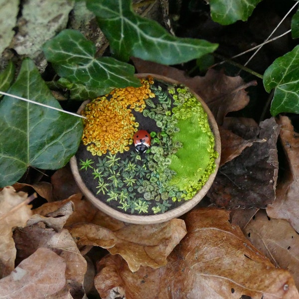 Tiny moss and lichen embroidery with hand made ladybird - two inches diameter, in a wooden tray.  (c)