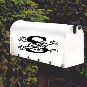 May include: White mailbox with a black vinyl decal featuring the letter "S" and the numbers "1234" with a decorative swirl design and stars.