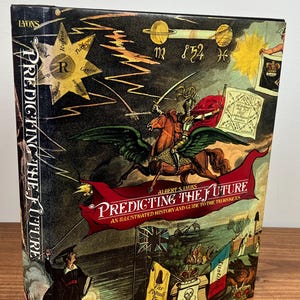 May include: A book cover with a colorful illustration of a winged knight riding a horse. The book title is "Predicting the Future: An Illustrated History and Guide to the Techniques".