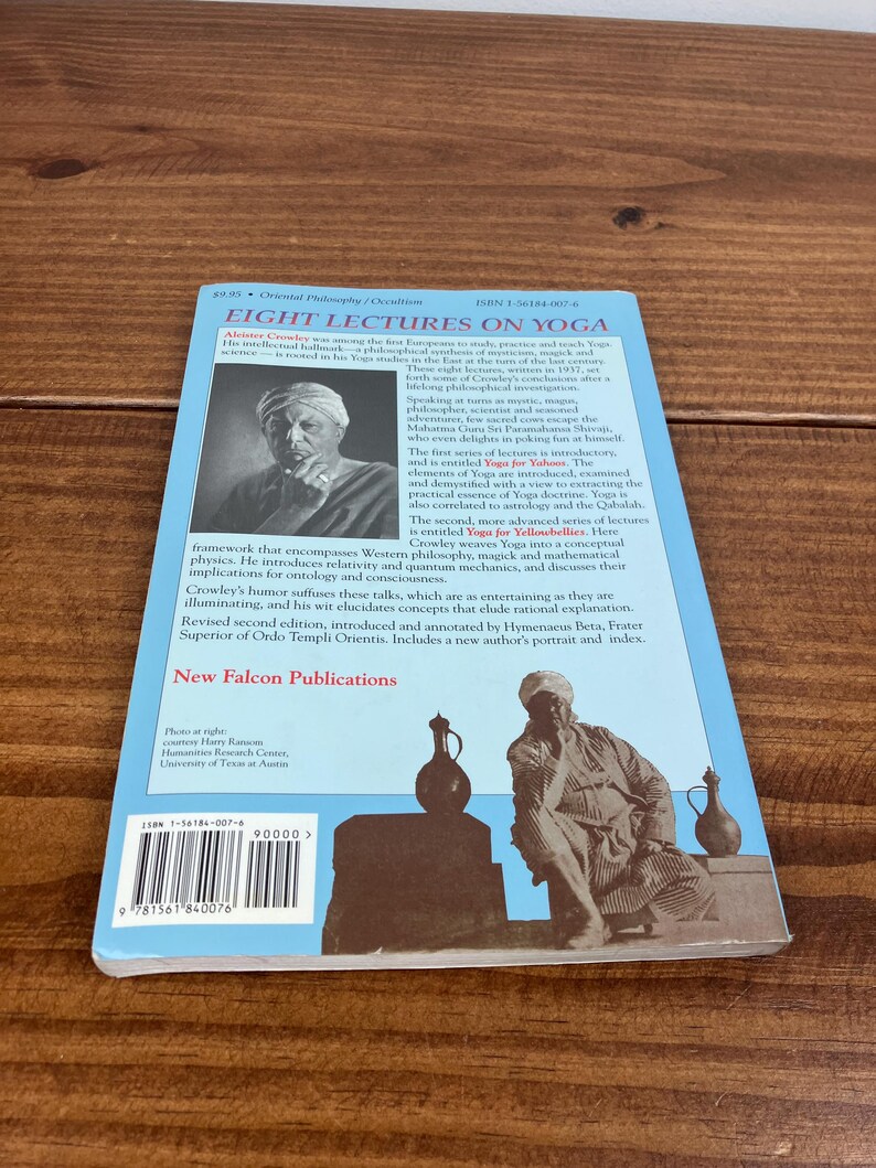 May include: A book titled "Eight Lectures on Yoga" with a blue cover and a black and white image of a man. The book is published by New Falcon Publications and includes text about yoga, philosophy, and the author.