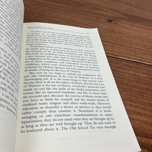 May include: An open book with text on a wooden surface. The text includes the title "Yoga for Yahoo 2 Yama". The page is open to a section discussing rules and liberty.