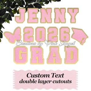 May include: Pink glittery double-layer cutouts spelling "JENNY 2026 GRAD" with gold borders. Includes a butterfly and graduation cap shape. The text "Custom Text double layer cutouts" is also displayed.