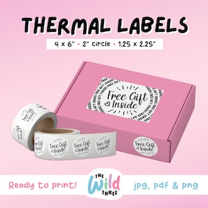 May include: A set of four white round thermal labels with black text that reads "Free Gift Inside". The labels are 2 inches in diameter and are shown on a pink box with the text "Free Gift Inside" repeated around the edge.