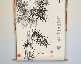 May include: A hanging scroll featuring a black and white ink painting of bamboo stalks and leaves. The artwork includes text and red stamps. The scroll is suspended by wooden dowels and colorful cords.