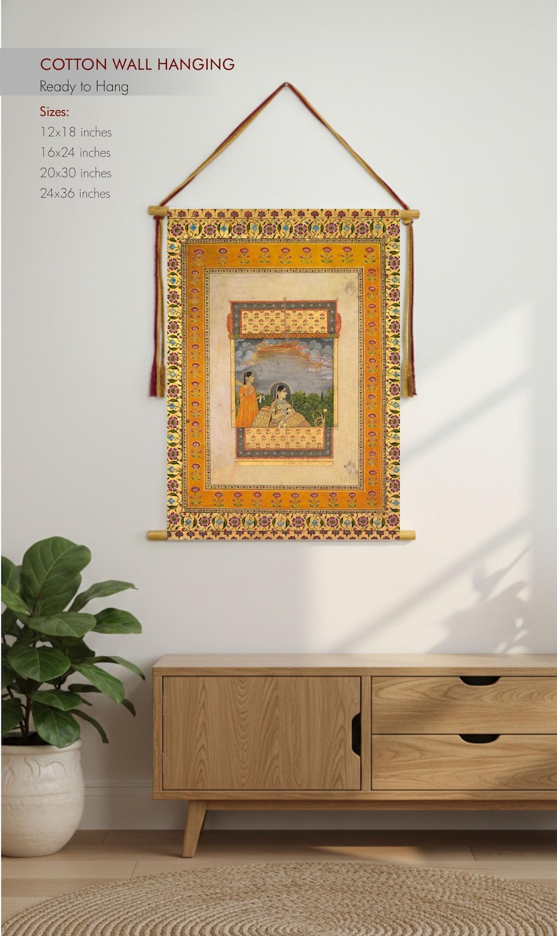 May include: Cotton wall hanging featuring a detailed illustration with figures in a garden setting. The artwork is framed with ornate borders in shades of orange and gold. Available sizes include 12x18, 16x24, 20x30, and 24x36 inches. Ready to hang.