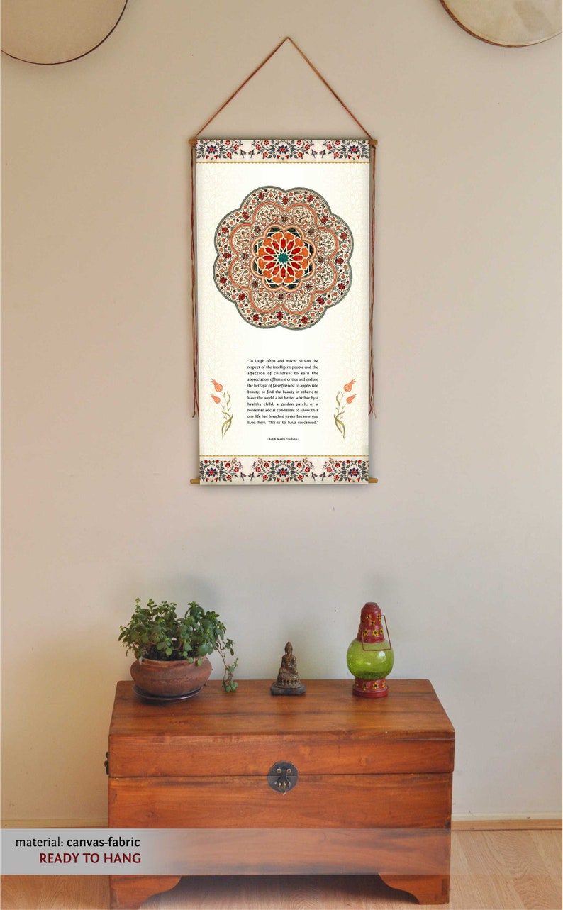 May include: A white canvas wall hanging with a colorful mandala design and a quote about the importance of children. The quote reads, "To laugh often and much, to win the respect of intelligent people and the affection of children, to earn the appreciation of honest critics and endure the betrayal of false friends, to appreciate beauty, to find the best in others, to leave the world a bit better, whether by a healthy child, a garden patch, or a redeemed social condition; to know even one life has breathed easier because you have lived here. This is to have succeeded." The wall hanging is ready to hang.
