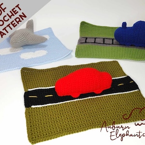 May include: Crochet pattern for a playset with a blue car, a red car, and a gray airplane. The cars are on green roads with black lines and the airplane is on a blue background with white clouds.