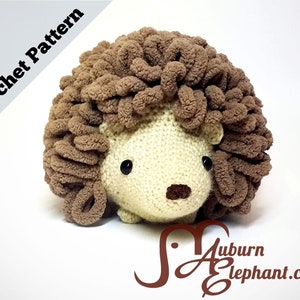 May include: A crocheted hedgehog amigurumi toy with brown yarn for the quills and beige yarn for the body. The toy has black eyes and a brown nose.