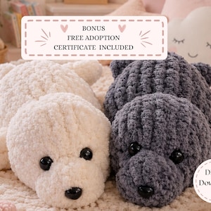 May include: Two plush stuffed animals made of chunky yarn, one cream-colored and one dark gray. Both have black plastic eyes and noses. A rectangular label reads BONUS FREE ADOPTION CERTIFICATE INCLUDED and a circular label reads Digital Download.