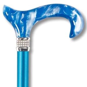 May include: A blue and white marbled walking stick with a silver band of rhinestones. The stick has a curved handle and a blue shaft.