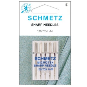 May include: A pack of five silver sewing needles labeled "Schmetz Microtex Sharp Needle 130/705 H-M".