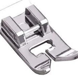 May include: A silver sewing machine foot with a small opening in the front and a larger opening in the back.