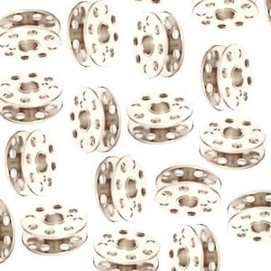 May include: A collection of 15 silver metal bobbins for a sewing machine.